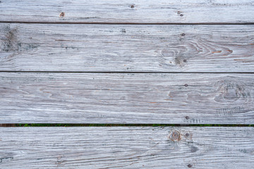 Naklejka premium Close up of the weather planks of a boardwalk. Useful as wooden background