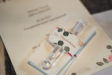 Closeup of guest gift pack containing paper tissues and transparent plastic bubble blower. Translation: "For tears of happiness". Wedding day concept.