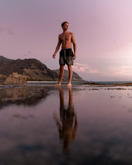 Fototapeta na wymiar Man standing shirtless near water