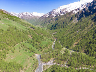 Fototapeta na wymiar alps mountains piedmont valley flight in a sunny day. aerial view