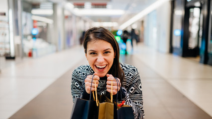 Excited shoppingholic woman in shopping mall.Buying in designer store.Wardrobe sale shopping.Hoby...