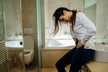 Woman having severe abdominal menstrual pain.Gastrointestinal autoimmune...