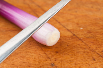 Onion on a cutting board isolated on a white background. Healthy food