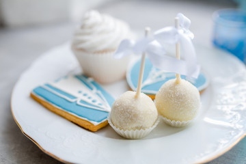 White cupcakes with sugar. Morning of the bride. Sweets and cakes are in candy bar for the wedding ceremony. Selective focus.