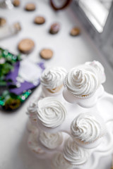 Cupcakes with white cream. Morning of the bride. Sweets and cakes are in candy bar for the wedding ceremony. Selective focus.