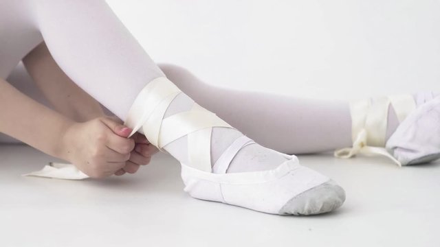 Close u of tying ballet shoes before training