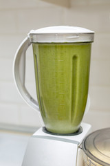 Cooking a healthy smoothie in a blender on the kitchen table.