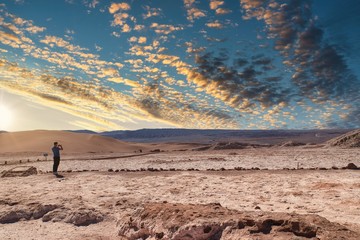 desert landscape with mountains, clouds and blue sky
