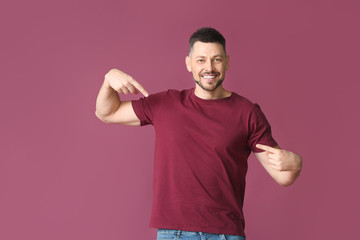 Man in stylish t-shirt on color background