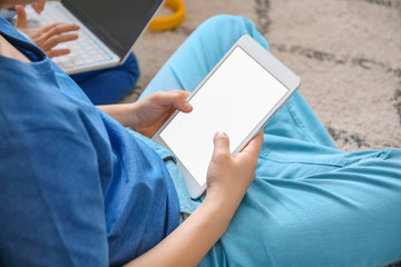 Cute little boy with tablet computer at home. Concept of online education