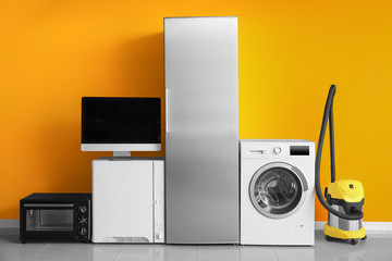 Different household appliances near color wall