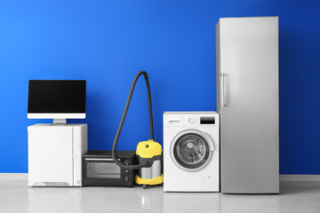 Different household appliances near color wall