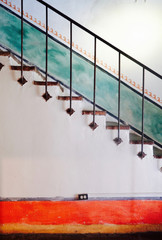 Colorful interior design stairs with wrought iron bannister Spanish adobe style USA