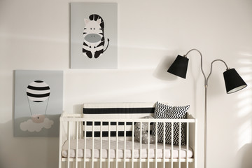 Cute baby room interior with crib and decor elements