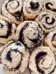 Cinnamon bun poppy seeds raisins cream glaze bakery product tasty dessert food photo