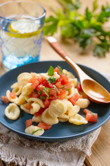 orecchiette with chopped tomato and parsley - traditional Italian food - closeup