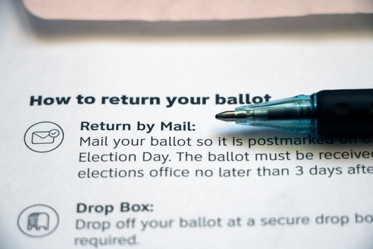 Instructions on a voting envelope with pen