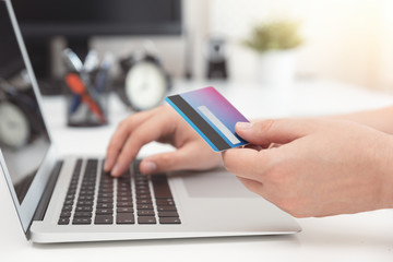 Online shopping, e-commerce. Credit card in hand.