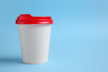 Takeaway cup for drink on color background