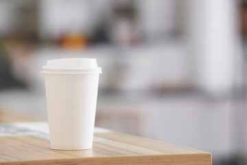 Takeaway cup for drink on table