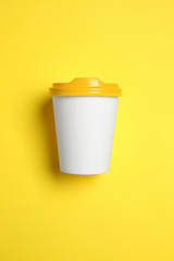 Takeaway cup for drink on color background