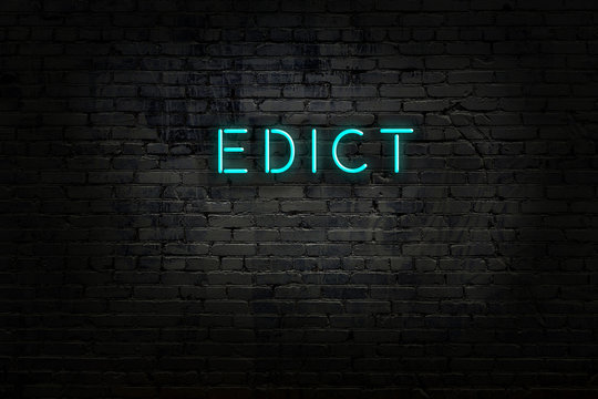 Neon sign with inscription edict against brick wall