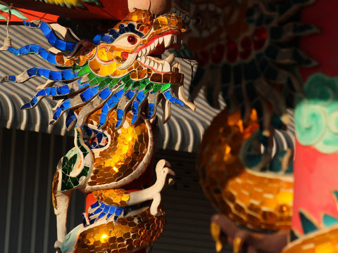 colorful glass mosaic dragon image as pillar decoration in a chinese temple in the city of savannakhet lao PDR