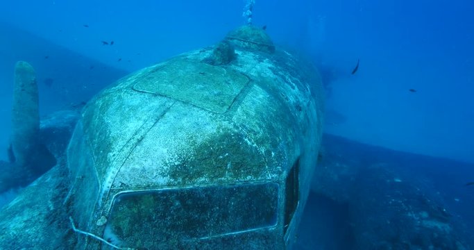 exploring underwater air plane wreck fish around ocean scenery of airplane scuba divers to enjoy