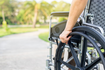 Close up of hands disabled woman sitting on wheelchair at outdoor