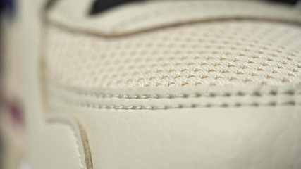 Extreme close up footage of perfect toe sneaker dolly in. Beige color. - obrazy, fototapety, plakaty