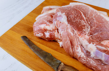 Fresh raw meat prepared for cooking on cutting wood
