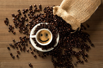 Good morning coffee smile cup and coffee beans on wooden background. Top view.