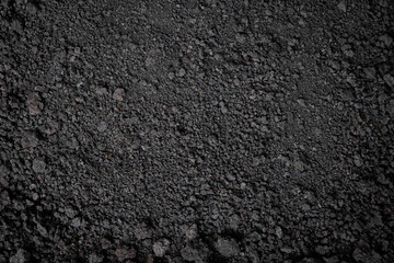 Top view, close-up of Organic black soil texture pattern background. Can be used planting tree. Surface has grunge and rough. Feature of compost fertile suitable for gardening and agriculture farm.