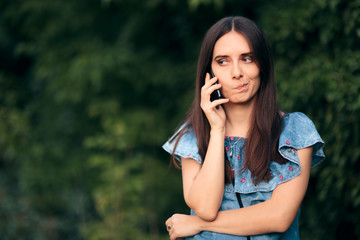 Worried Woman Talking At the Phone Outdoors
