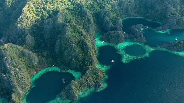 View from above, stunning aerial view of the Twin Lagoons surrounded by rocky cliffs. The Twin Lagoons are one of the must-see destinations in Coron Island. Palawan, Philippines.
