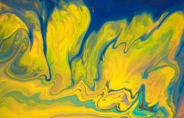 Liquid yellow and blue abstract texture. Art technique. Smudges of acrylic bright colors. Mixed inks pattern.