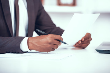 Cropped African Businessman Holding Document.