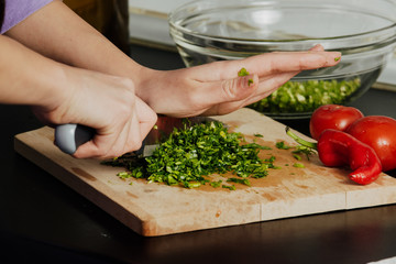 Woman cuts vegetables. The concept of eco-friendly products for cooking.