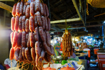 homemade sausages on a rope for sale at a farmers market