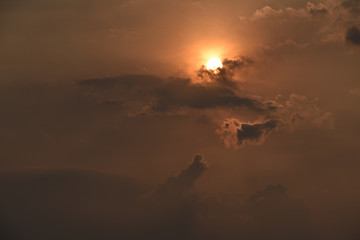Beautiful cloudy sunset sky. bright sun peeps out of the storm clouds. Sunset colors