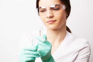Medicine concept, doctor female in clinic holding test tubes with experimental vaccine