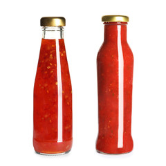 Delicious sauces in glass bottles on white background