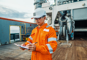 Filipino deck Officer on deck of offshore vessel or ship , wearing PPE personal protective...