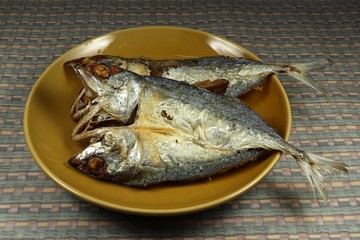 Deep fried crispy mackerel fish with local sauce on the plate. Famous Traditional Thailand food serving with chilly shrimp paste. Whole fried seafood menu.
