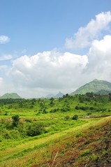 Green hills and heavy clouds in the sky