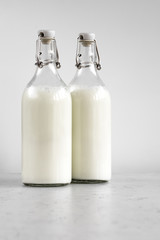 milk drink in glass bottles, healthy eating concept, vertical orientation, flat layout
