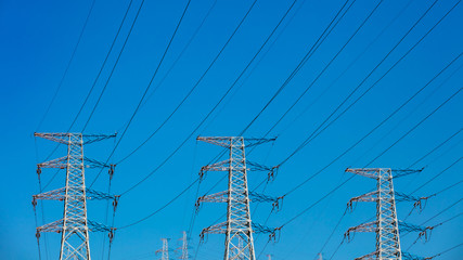 High power electricity poles connected to smart grid at clear sky