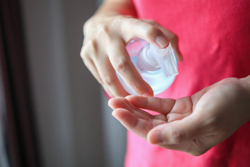 Woman using alcohol sanitizer gel rub for cleaning hand COVID-19 corona virus prevention concept