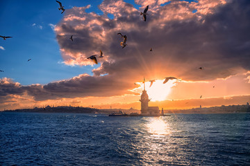 Fiery sunset over Bosphorus with famous Maiden's Tower (Kiz Kulesi) also known as Leander's Tower,...