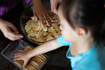 Kids making Kek Batik or Malaysian Triple Chocolate Dessert. Doing the initial steps, crushing the...